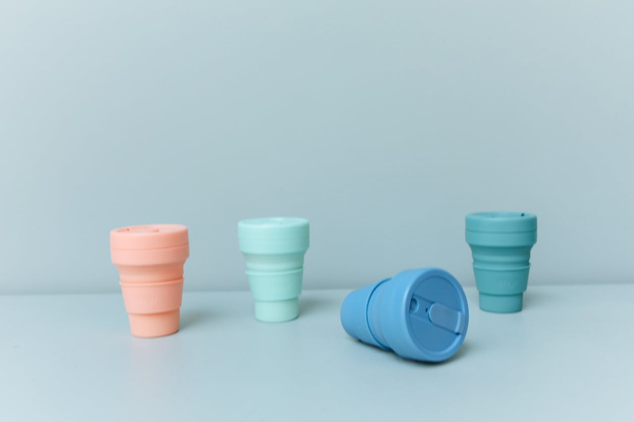 A set of pastel-colored collapsible cups promoting eco-friendly and zero waste lifestyle.